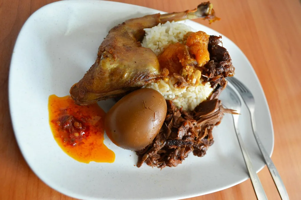Plate of gudeg with rice and side dishes in Yogyakarta